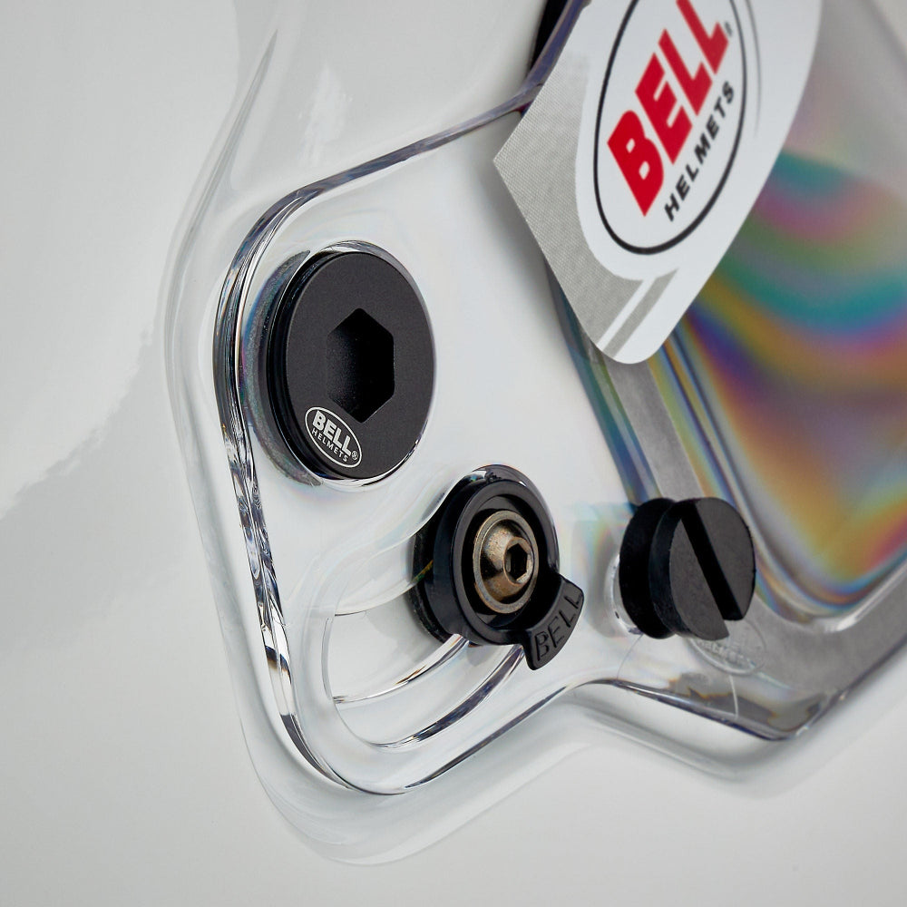 Close-up of a Bell helmet with clear visor and black adjustment knobs.