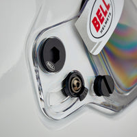 Thumbnail for Close-up of a Bell helmet with clear visor and black adjustment knobs.