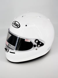 Thumbnail for A white Arai full-face racing helmet with a clear visor, photographed on a light gray studio background.