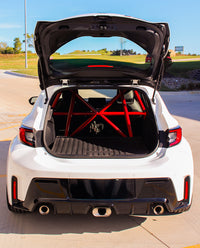 Thumbnail for GR Corolla bolt-in roll bar from CMS Performance viewed through the open rear hatch