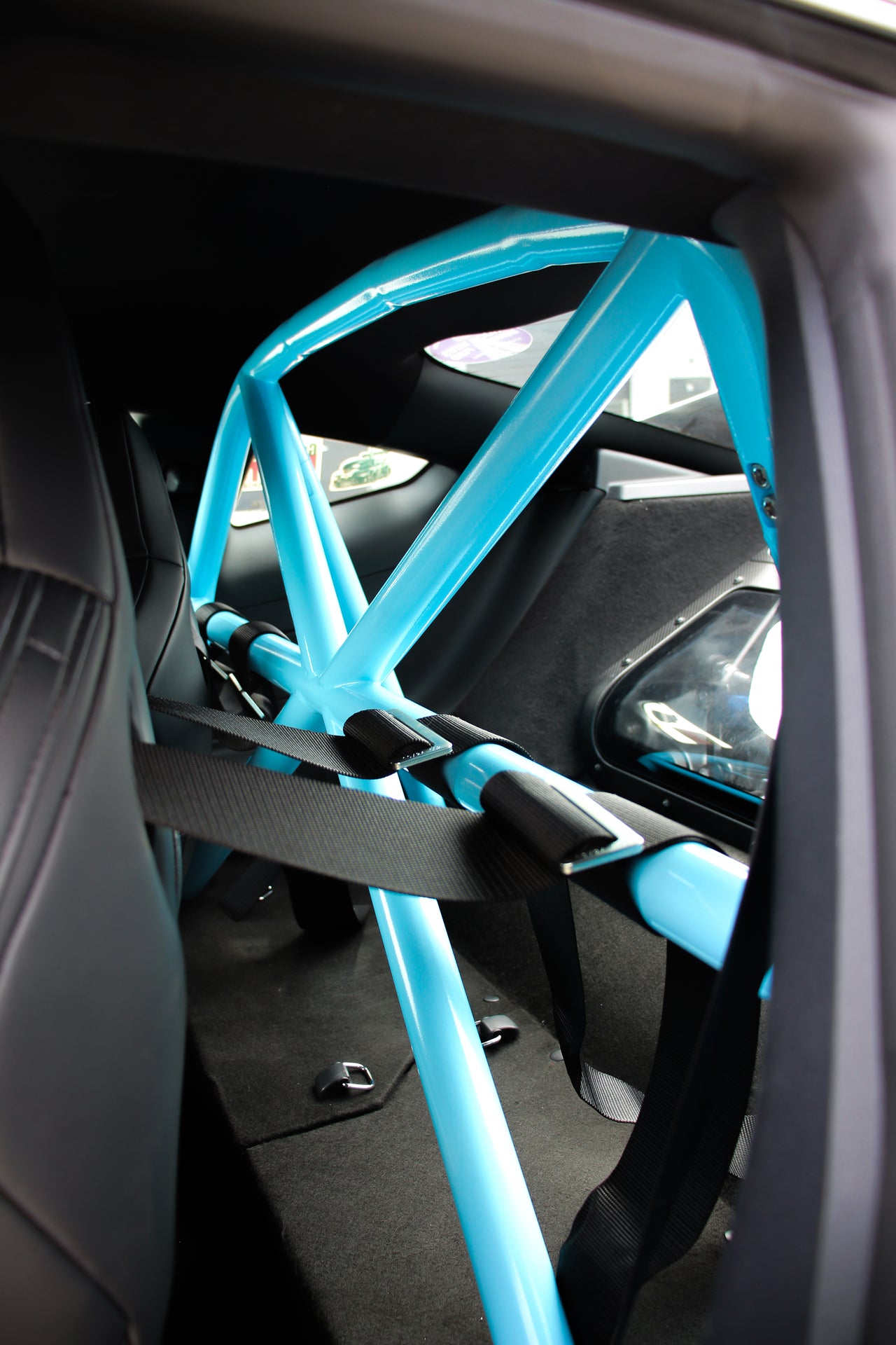 Blue CMS roll bar inside a Mustang GTD  with racing harnesses