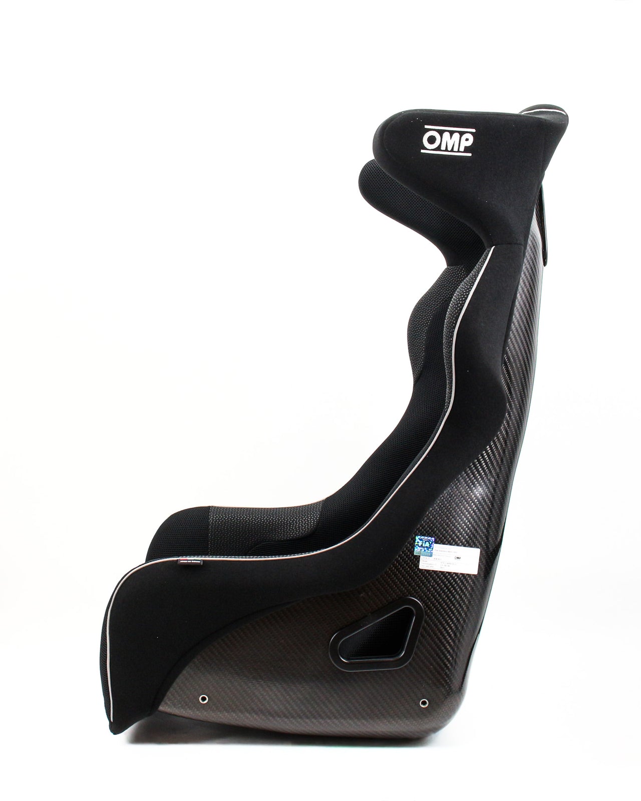 A black OMP racing bucket seat with a carbon fiber pattern side panel, white piping, and a white OMP logo on the headrest, shown from a side profile on a white background.