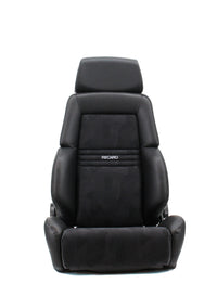 Thumbnail for A black Recaro car seat with a textured patterned center panel and white Recaro branding, shown against a plain white background.