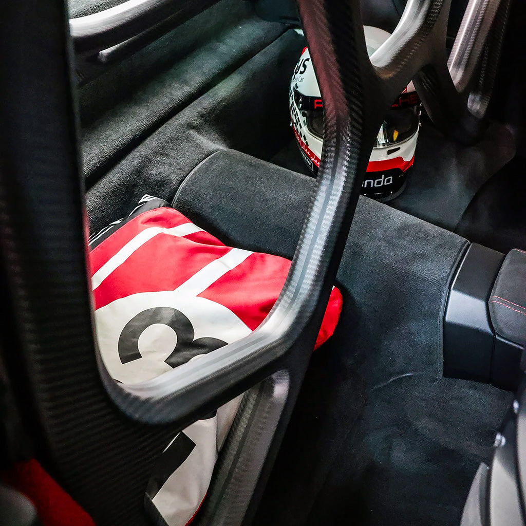 Symmetrical structure of SilverRocket carbon roll cage inside 992 GT3 RS

