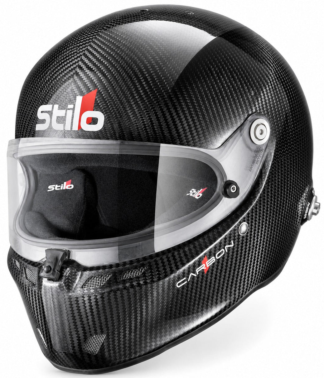 A Stilo full-face racing helmet in glossy black carbon fiber, featuring a clear visor and white and red brand logos on the forehead and chin.