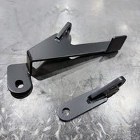 Thumbnail for CMS Performance GR Corolla harness install kit powder coated satin black on a steel welding table