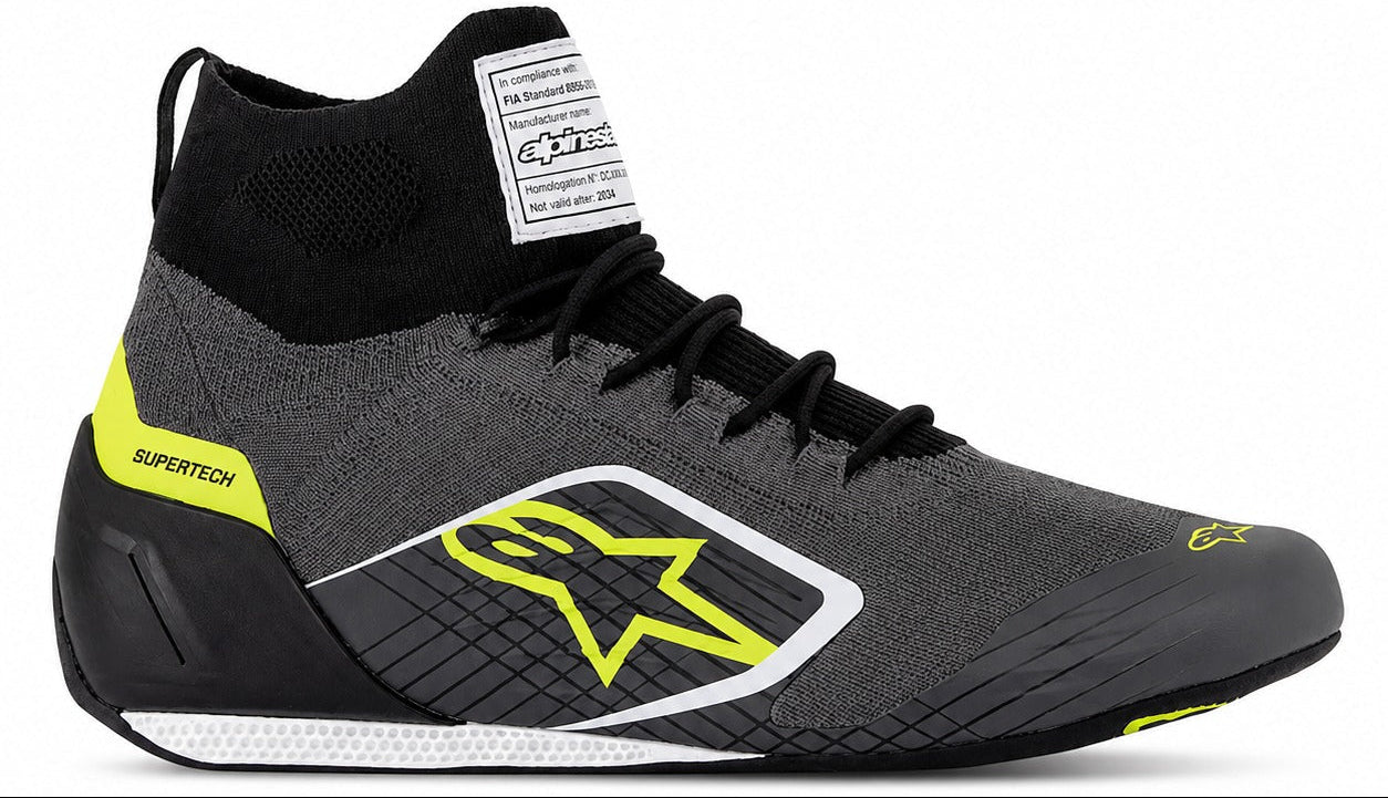 Alpinestars Supertech Racing Shoes in gray and yellow, single right-facing racing shoe with knitted upper, black laces, carbon-style heel cup, and thin racing outsole.