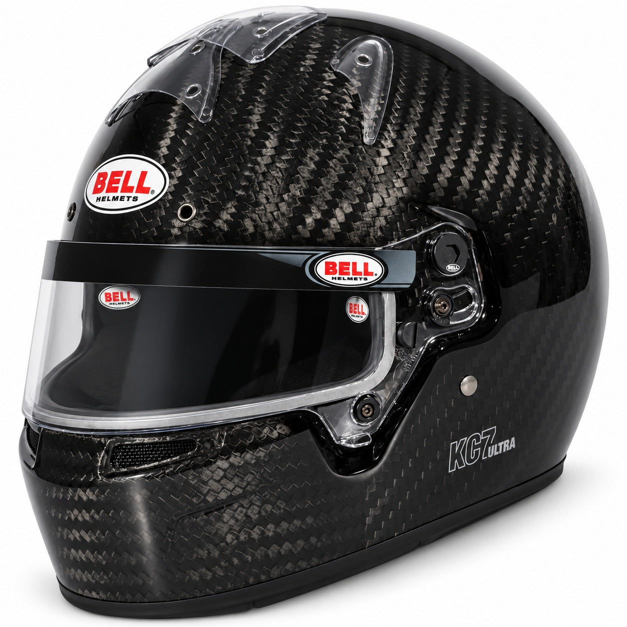Bell KC7 CMR Ultra Carbon youth karting helmet with exposed carbon fiber shell, clear visor, integrated ventilation, and front three-quarter view on a white background.