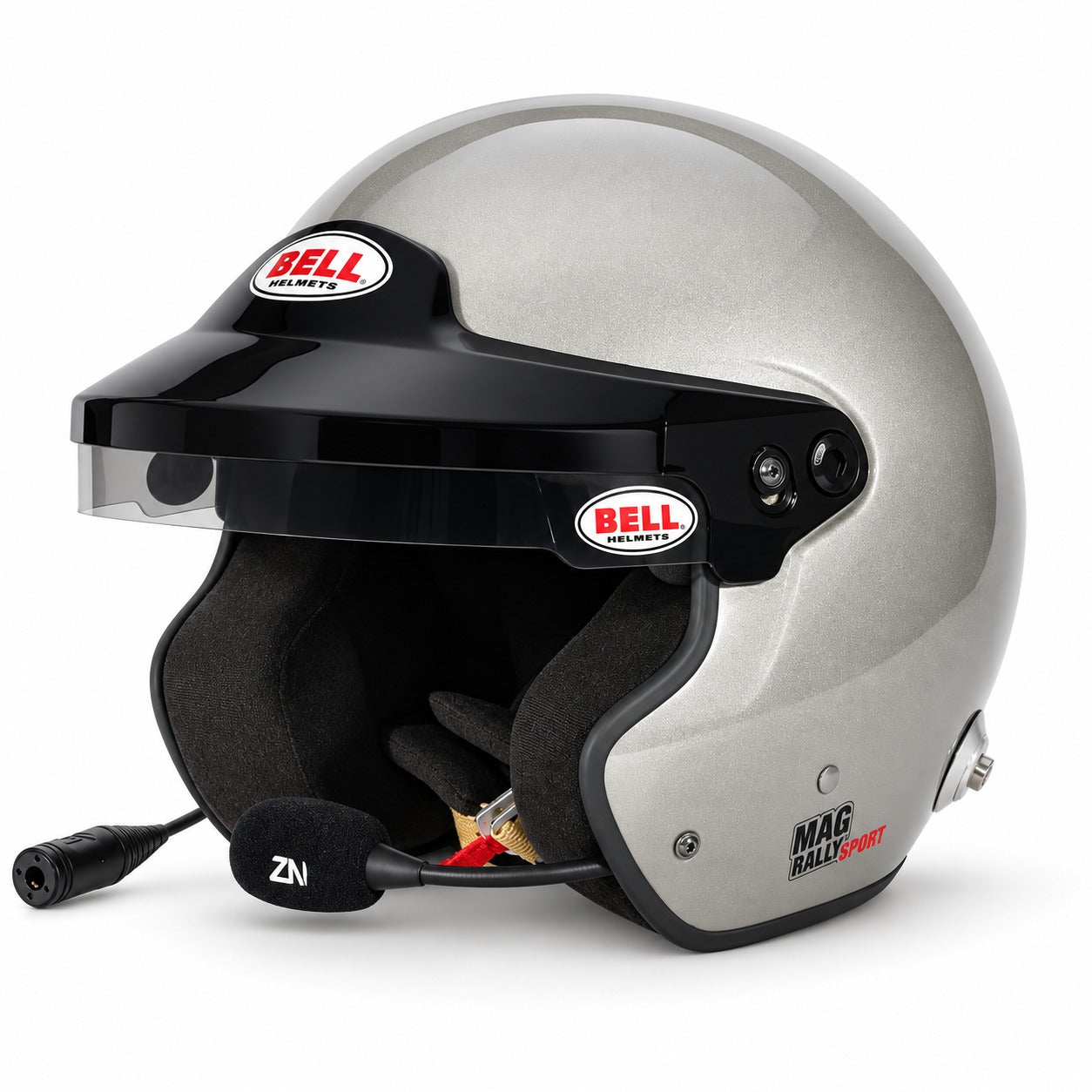 Bell MAG Rally FIA 8859-2024 open-face racing helmet in Titanium Silver Metallic, shown from a front three-quarter angle featuring integrated ZeroNoise communications, noise-canceling boom microphone, adjustable black sun peak, anti-glare sunscreen, black fire-resistant interior, and factory-installed HANS anchors on a clean white background.