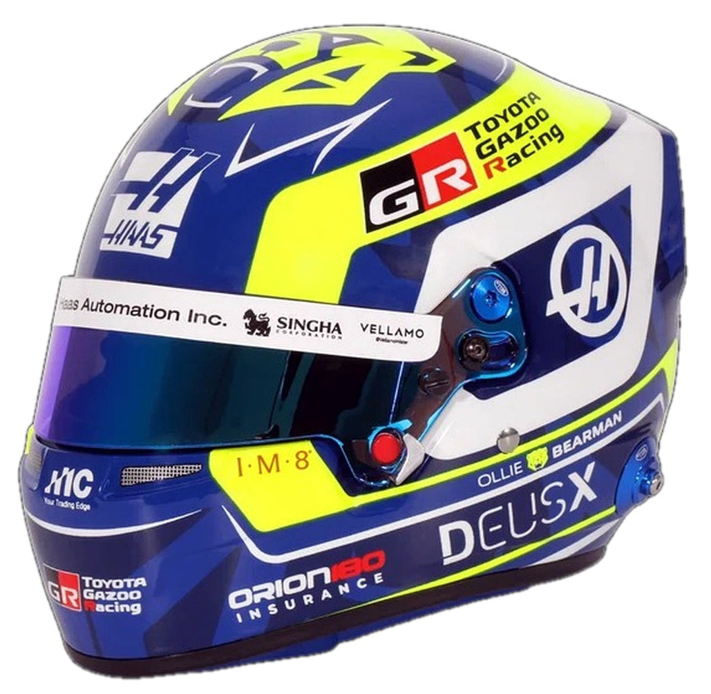 Bell Oliver Bearman 2026 F1 mini helmet front three-quarter view with blue, yellow and white Haas racing graphics