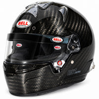 Thumbnail for A Bell RST Ultra full-face racing helmet in a glossy black carbon fiber pattern, featuring a clear visor and multiple red and white Bell helmets logos.