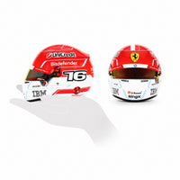 Thumbnail for Charles Leclerc 2026 F1 mini helmet scale comparison showing side and front views on black background`