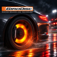 Thumbnail for Girodisc hero featuring a glowing orange rear brake rotor, flying sparks, and vivid reflections on a wet racetrack at night.