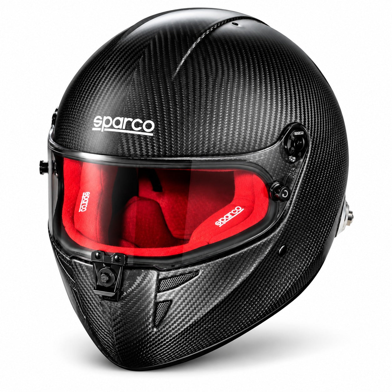 Sparco Stealth RF Carbon SA2025 racing helmet in three-quarter front view, featuring an exposed carbon fiber shell, red fire-resistant interior padding, clear visor, central locking mechanism, and HANS anchors.