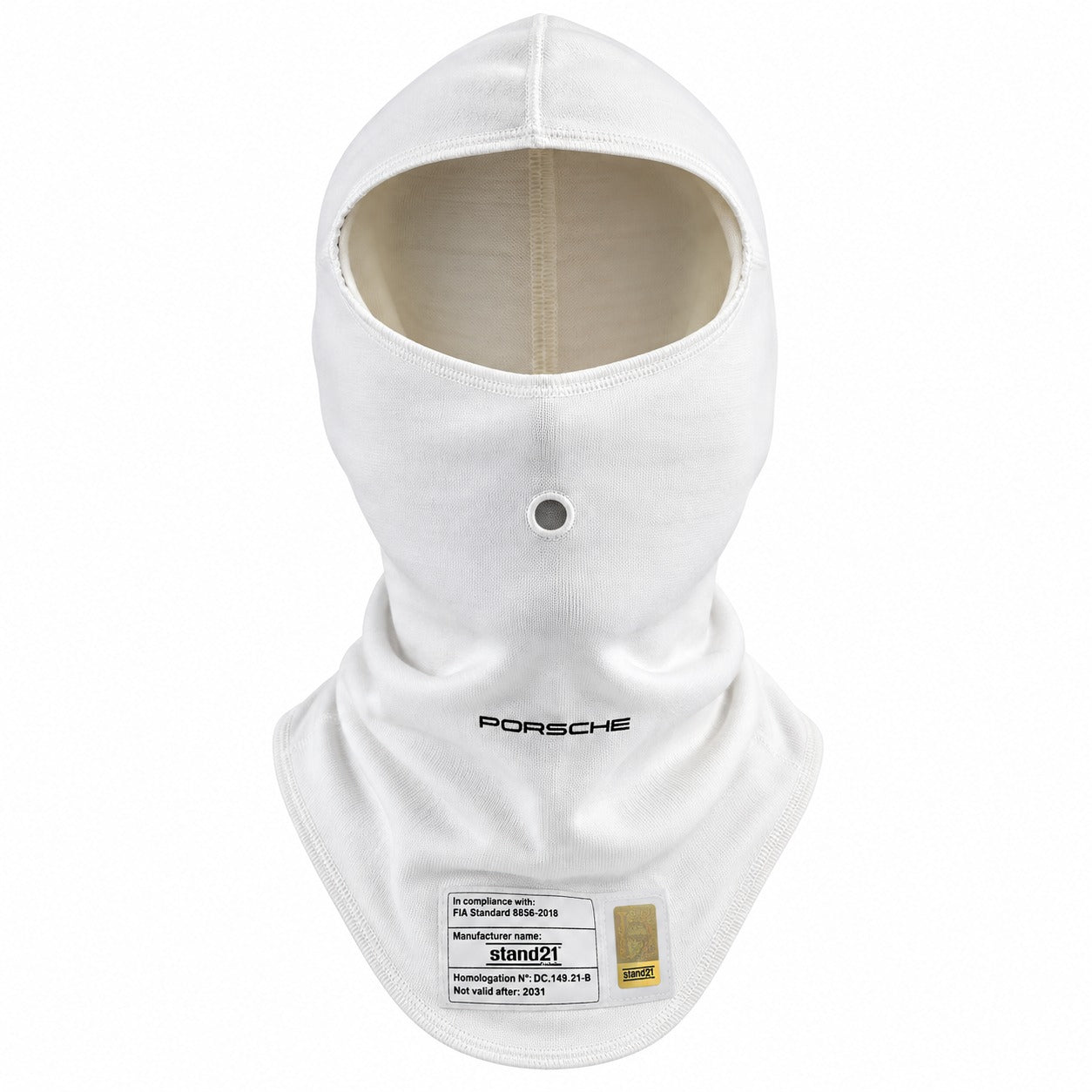 A white Stand21 Porsche Motorsport full-face balaclava hood with a neck gaiter, featuring a black Porsche logo on the chest and a white technical specification label near the bottom.  Created by Competition Motorsport