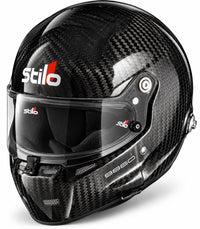 Thumbnail for Stilo ST5 GT Carbon Fiber Racing Helmet with FIA 8860-2018 certification, shown in a front three-quarter view featuring a glossy exposed carbon fiber shell, clear racing visor, center shield locking mechanism, integrated chin ventilation, HANS anchor, and Stilo branding on a clean white background.